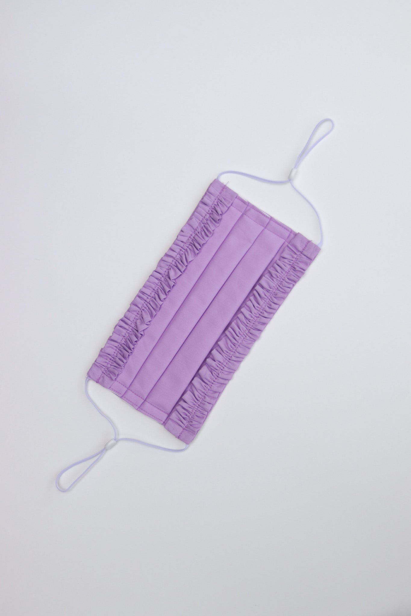 Triple-layer pleated style mask with adjustable ear clasps that ensure a snug and comfortable fit.