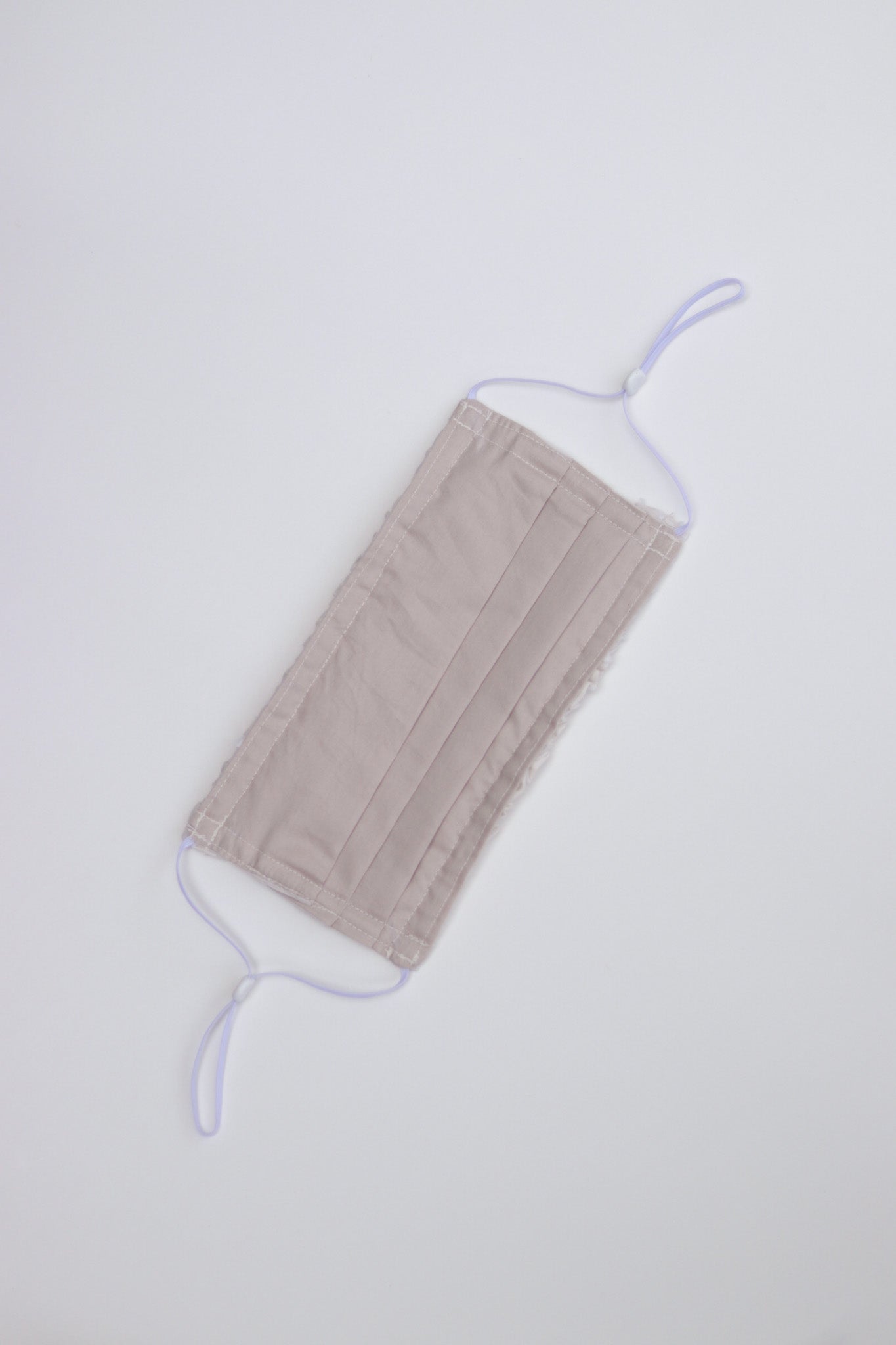 Triple-layer pleated style mask with adjustable ear clasps that ensure a snug and comfortable fit.