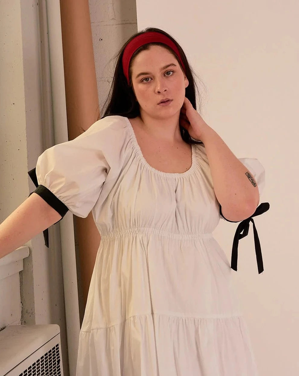 Overall white dress with extra puffy sleeves, gathered tiers, and black bow-tie details, the Jolen dress is both elegant and incredibly comfortable too. It's fully lined with cotton, slips on easily over head, and has pockets.