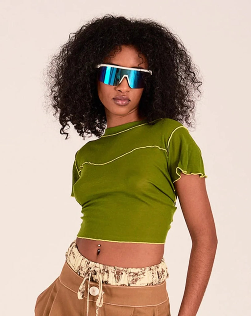This cropped green coloured tee is made out of a super soft blend of tencel and wool, but is still lightweight enough to wear during warm weather. The best parts are the exposed greenish yellow stitching and the super sweet ruffles on the hem and sleeves. It has a cropped fit that sits just above high-waisted jeans.