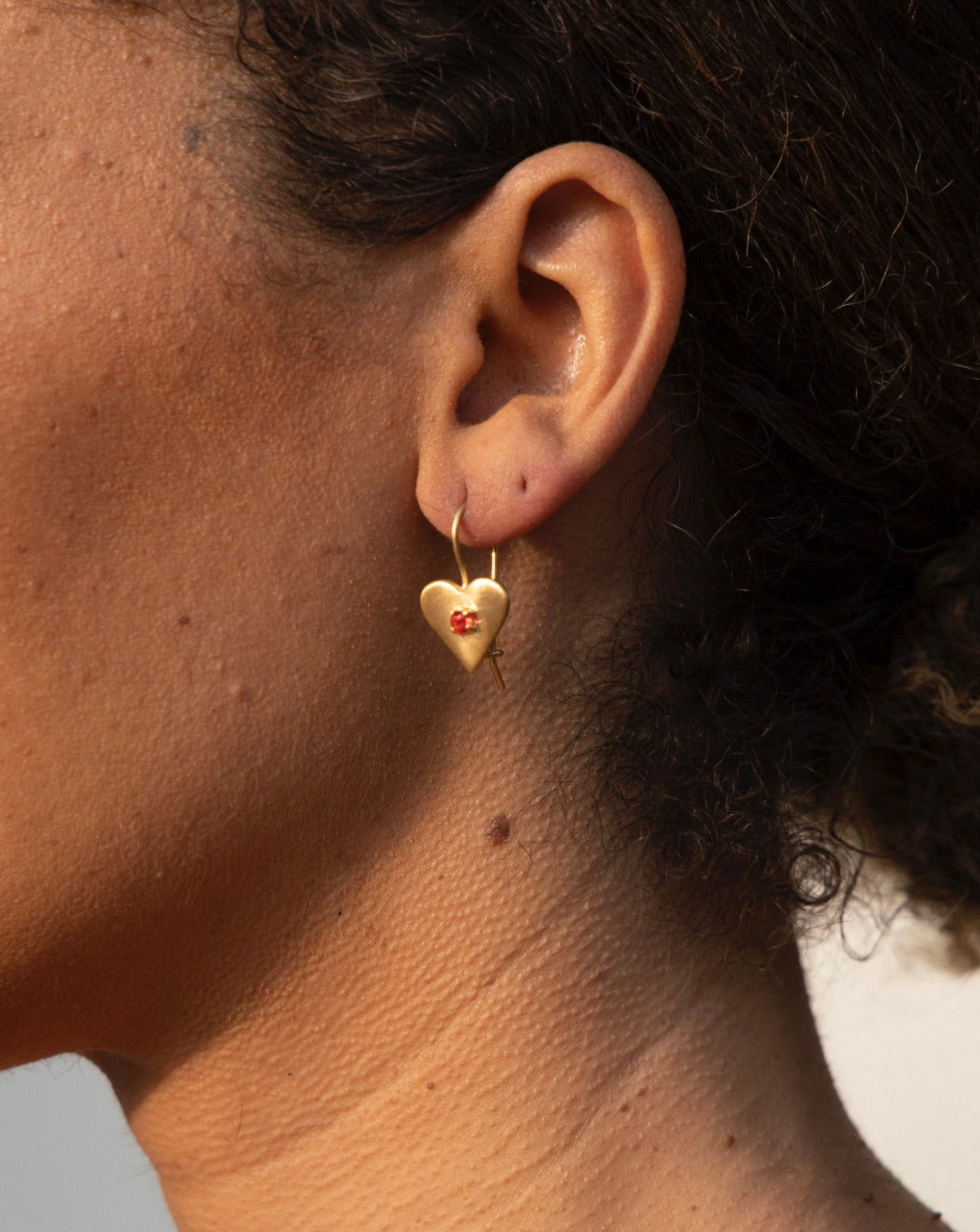Pair of 18k gold vermeil drop earrings set with red faceted glass stones.