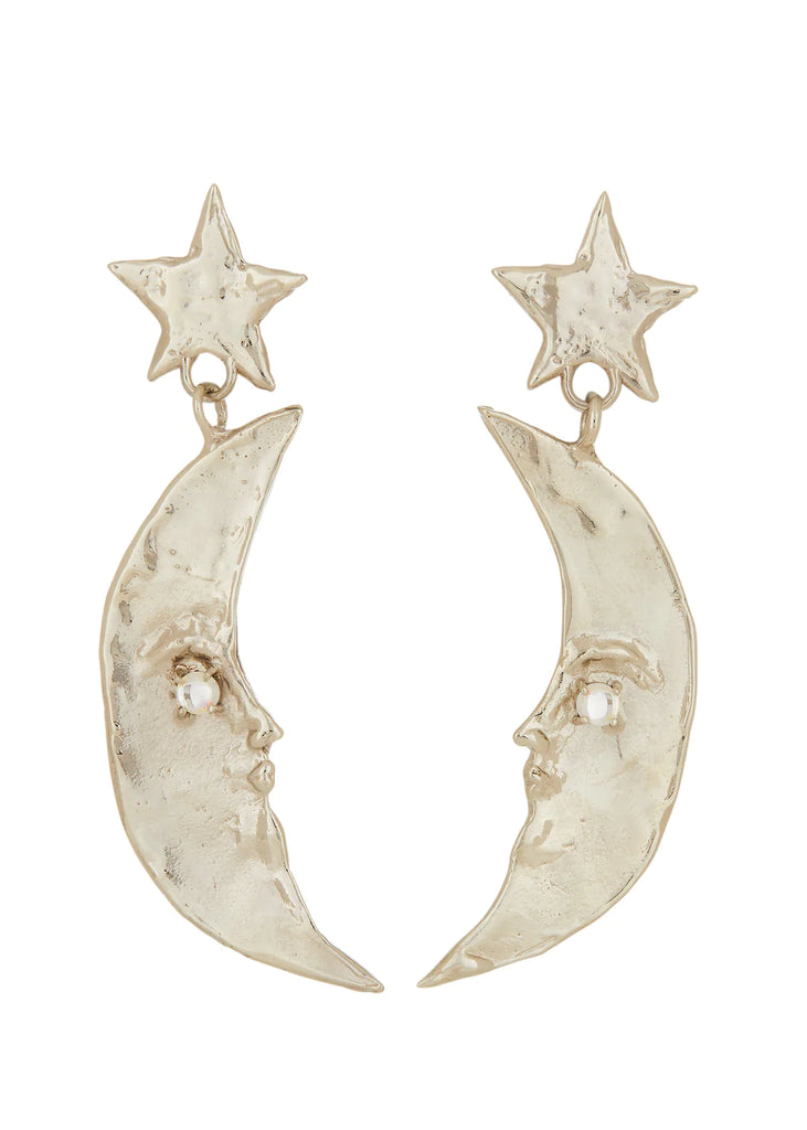 Half moon shaped earrings with face dangling from stars. White bronze, 4mm glass stone, sterling silver ear post. Available at Ease Toronto.
