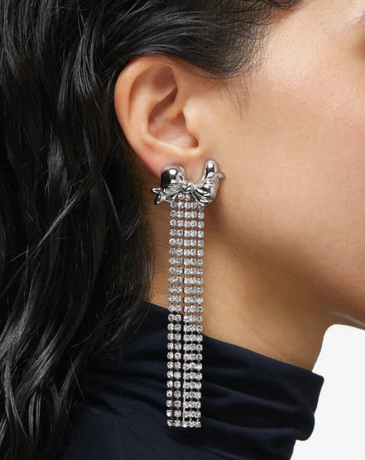 Silver-plated bow earrings with crystal chain fringe.