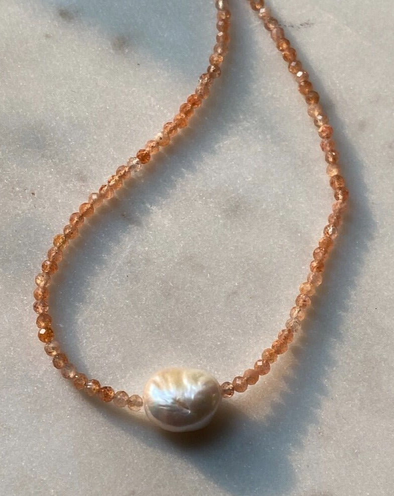 Orange sunstone gemstone necklace with an organic saltwater Pearl pendant in centre 