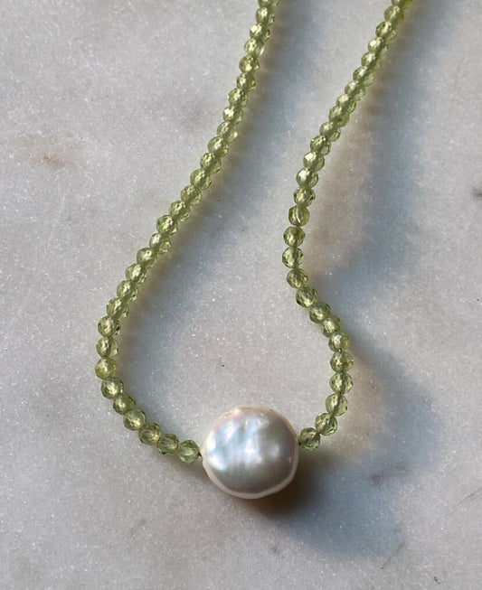 Green periodt gemstone necklace with an organic saltwater Pearl pendant in centre 