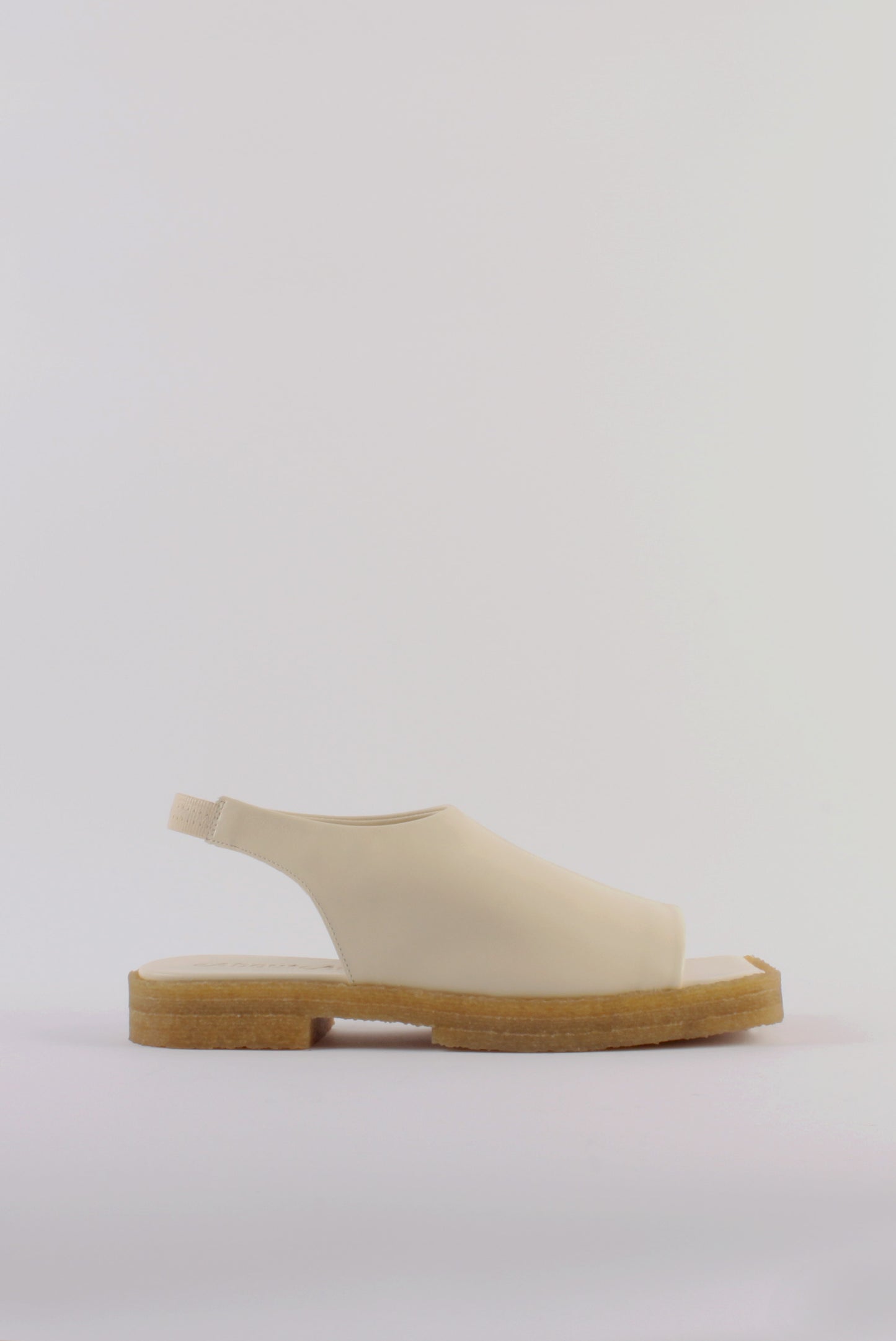 Unlined block platform sling-back sandals made of cream coloured lamb leather with a subtle shiny finish