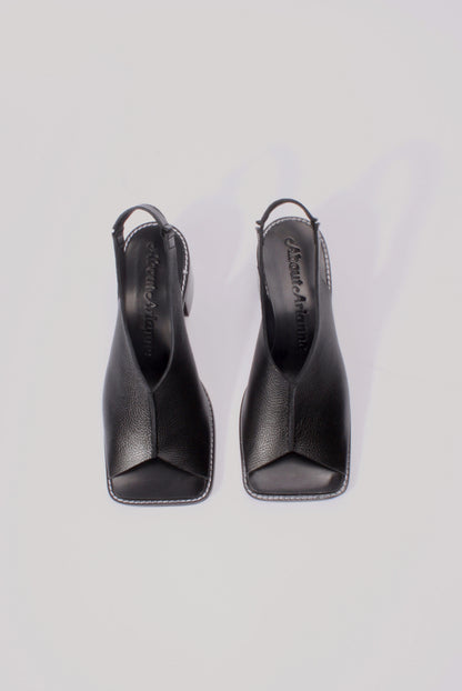 About Arianne block heel sling-back sandals made of black tumbled leather with raw edges