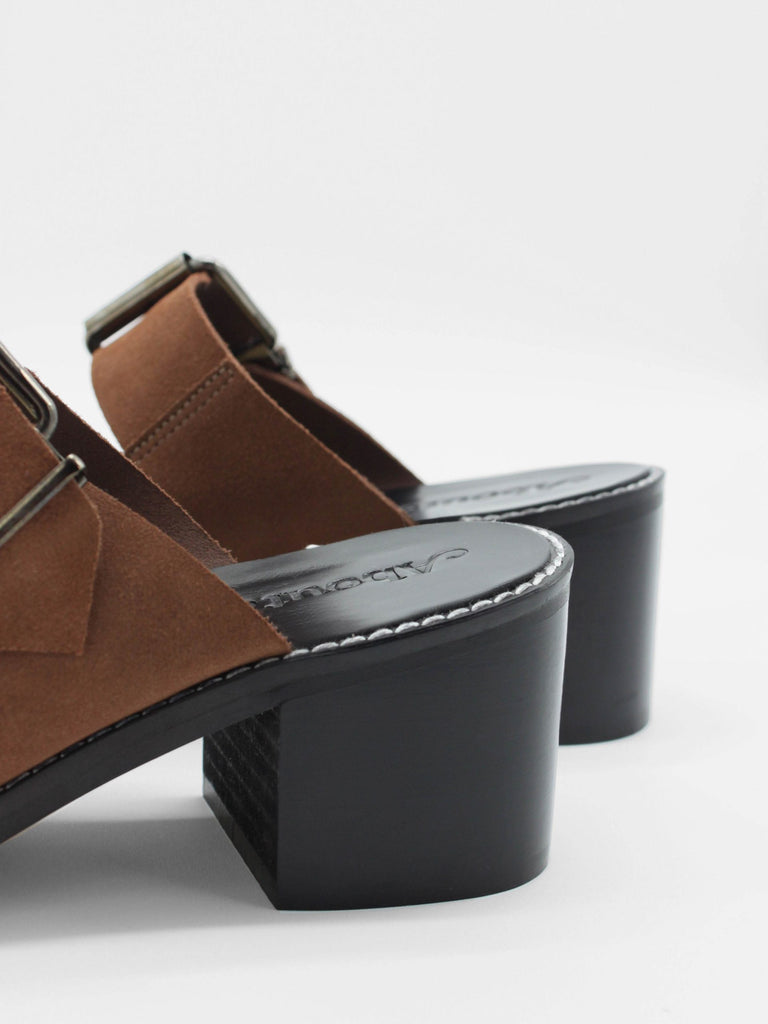 About Arianne mocha brown block heel mules made of brown split-cow leather with raw edges and a resined interior