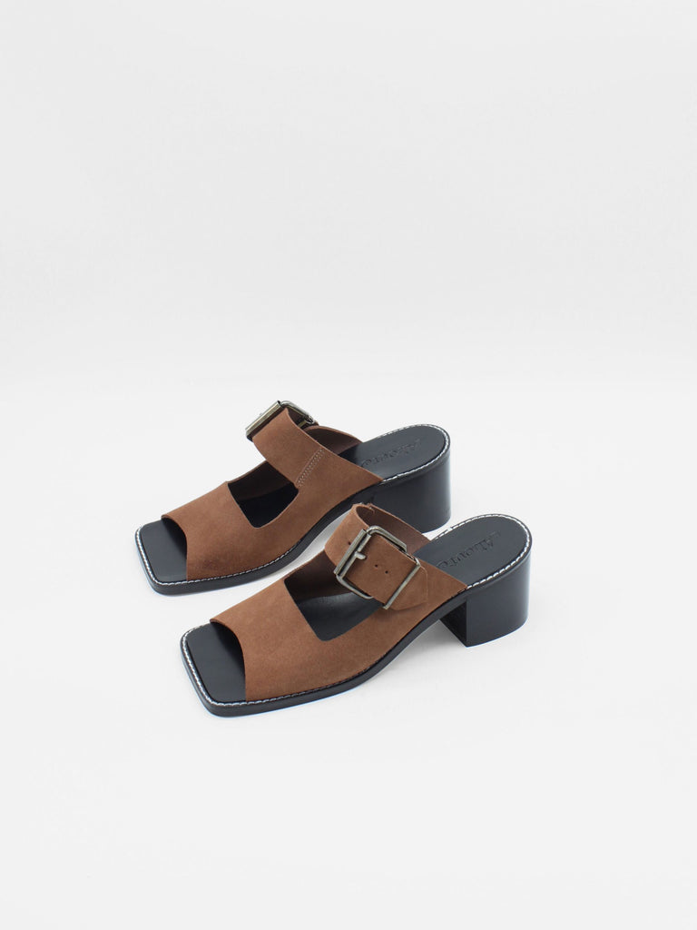 About Arianne mocha brown block heel mules made of brown split-cow leather with raw edges and a resined interior