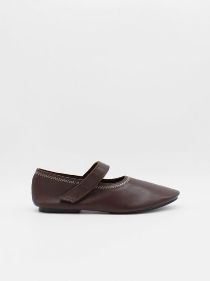 Unlined flat mary-jane made of dark brown lamb nappa leather with a shiny finish and stitching details. 