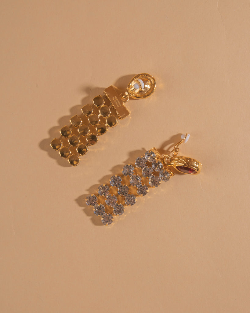 Pair of 18k gold plated clip-on earrings with glass crystal center stone and crystal chain.
