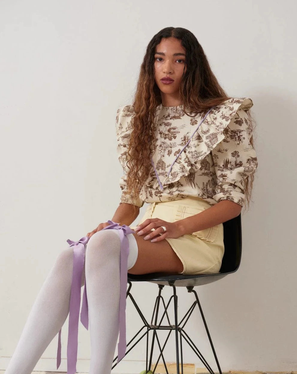  brown Toile de Jouy with bold lilac piping and matching grosgrain ribbon to really make it pop. The leg-o-mutton puff sleeves are lined with tulle for maximum volume. 100% Cotton. Slips on over head and ties in a bow at the back neck