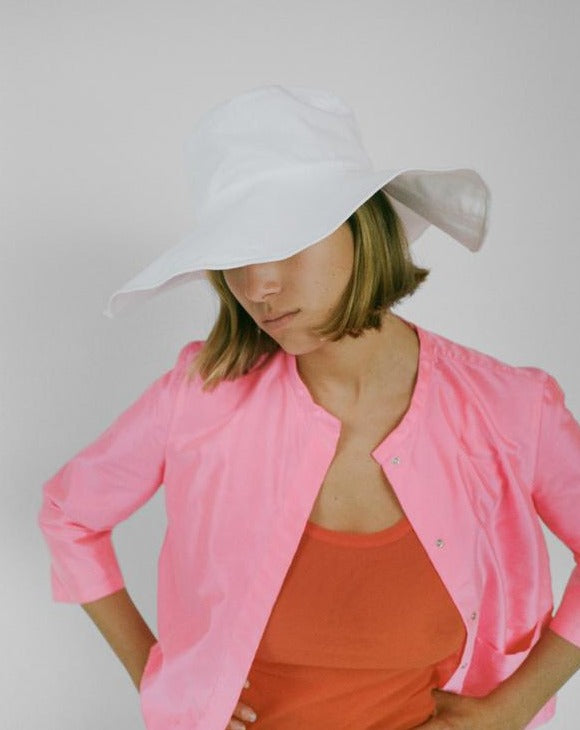 Clyde cotton wide brim floppy white sunhat. Available at Ease Toronto