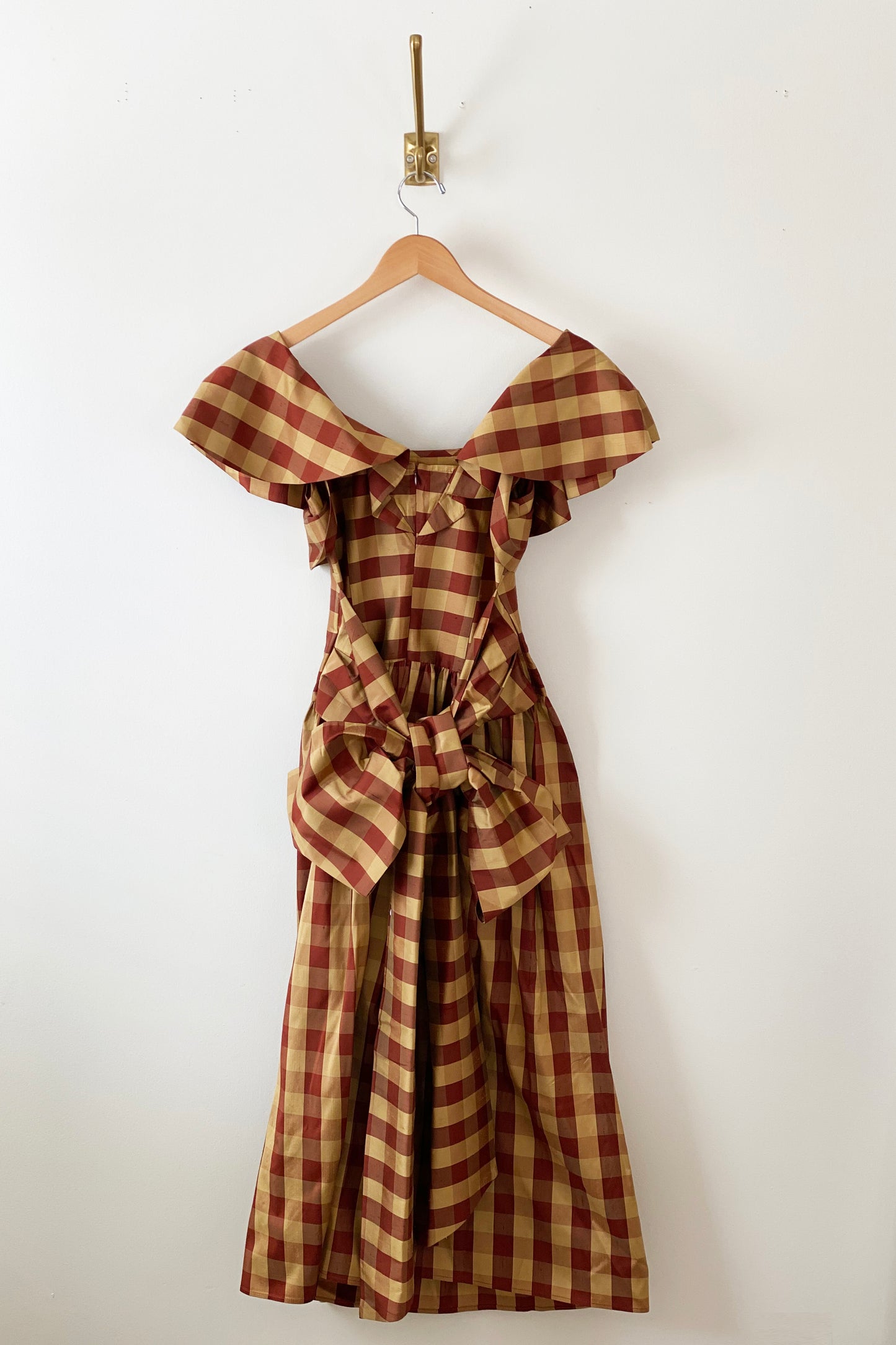 Batsheva Long Bow Dress in Sienna and Gold Check, back detail. Available at EASE Toronto. 