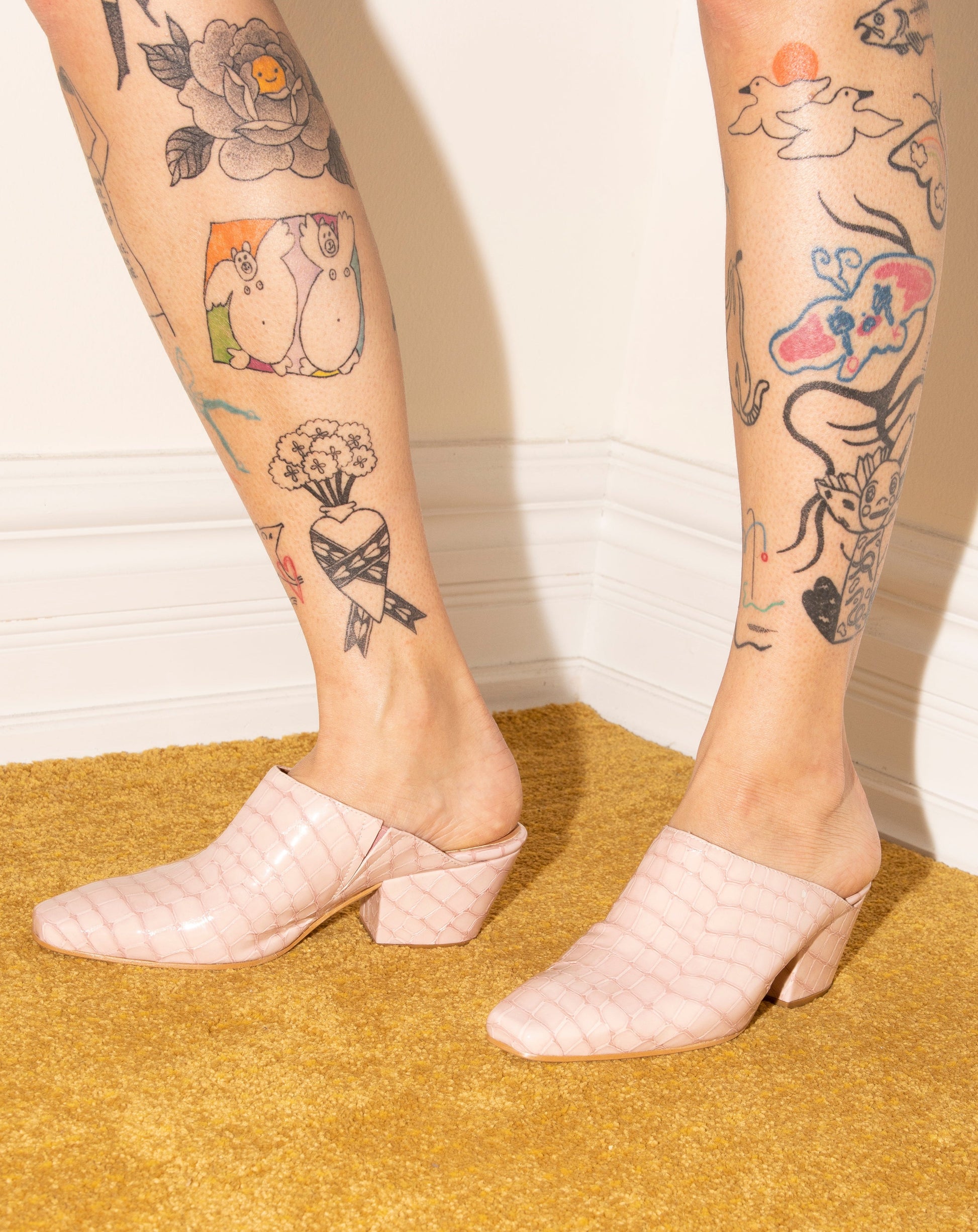 Pink 100% leather crocodile effect mules with almond shaped toe and block heel available at EASE Toronto