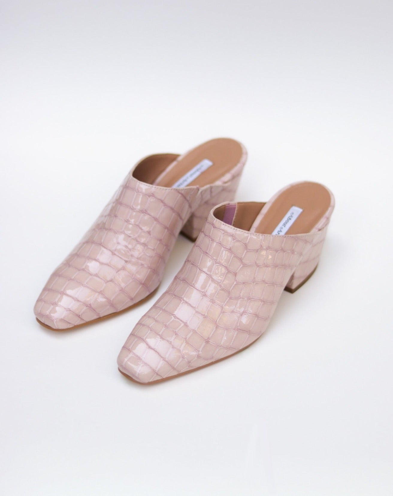 Pink 100% leather crocodile effect mules with almond shaped toe and block heel available at EASE Toronto