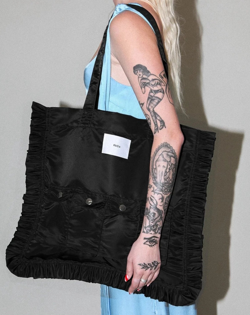 Black KkCo oversized Utility tote with ruffle and front pocket detail available at Ease Toronto