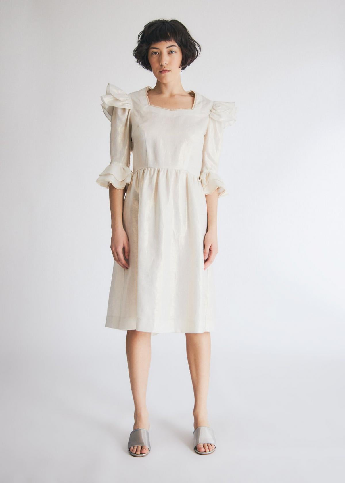 Batsheva Antoinette Dress in Gold Coated Linen. Available at EASE Toronto. 