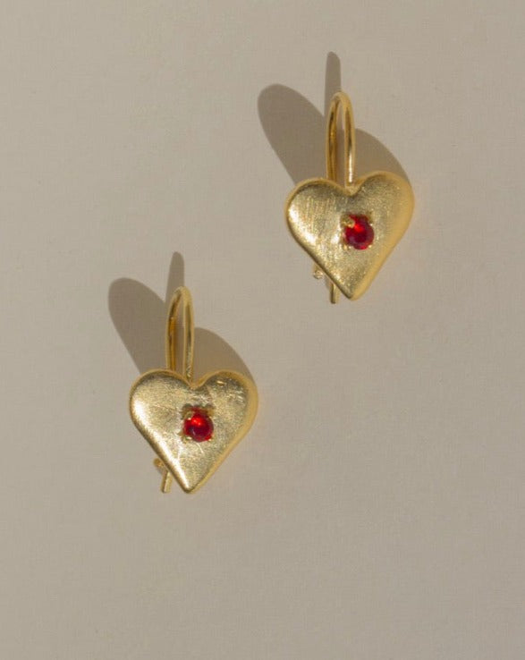 Pair of 18k gold vermeil drop earrings set with red faceted glass stones.