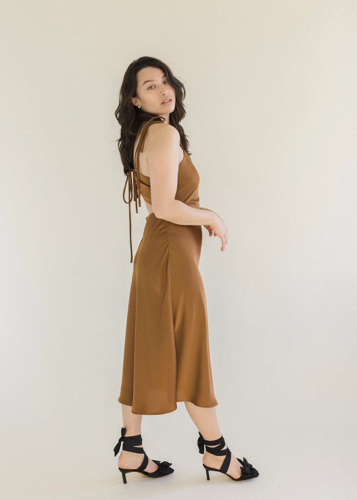  Cocoa coloured slip dress hitting mid calf, with adjustable thin shoulder and back straps that tie as bows with open lower back.