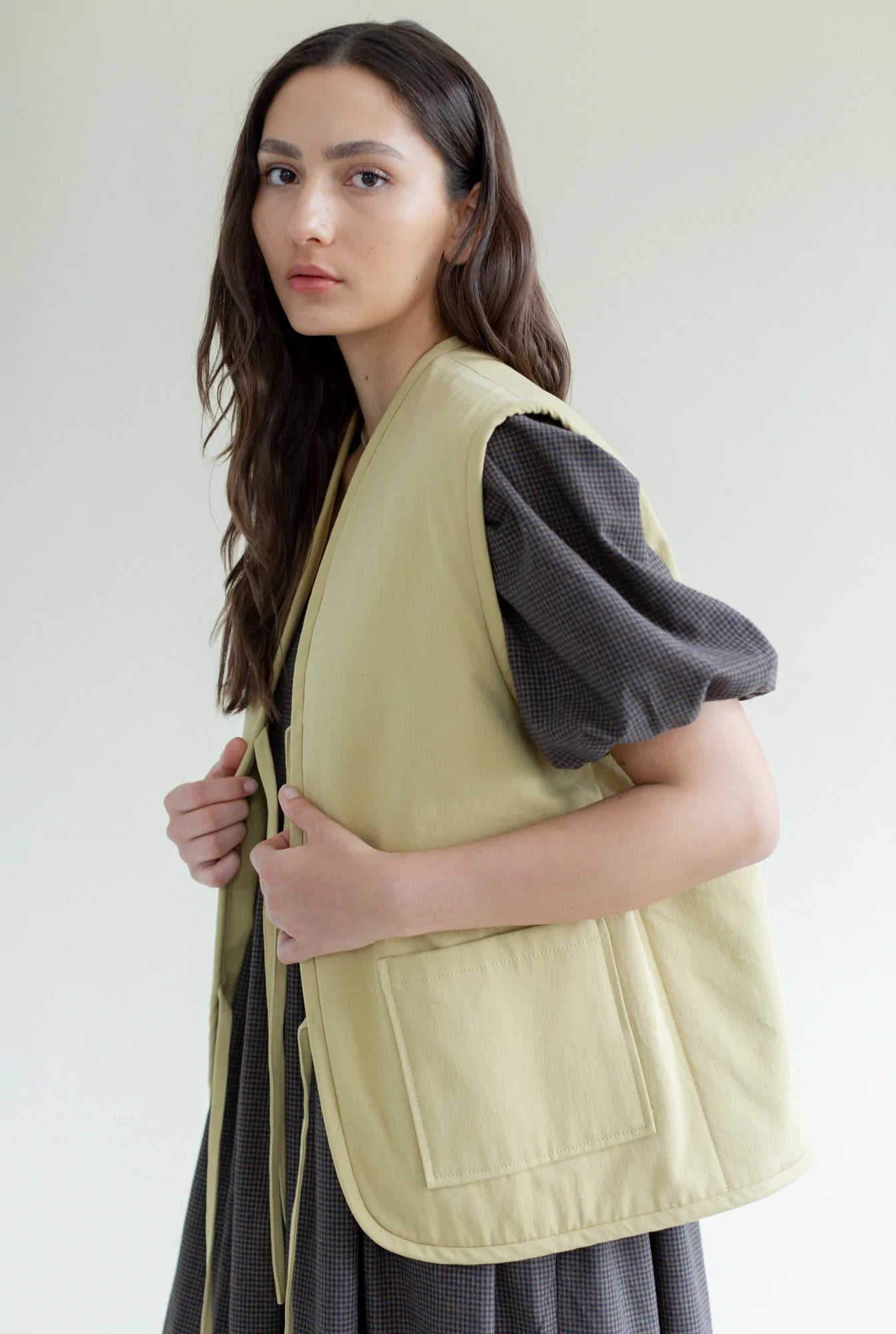 Oversized fit vest with 2 front pockets, 4 long straps to tie as bows or leave open, in flax colourway 